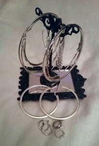 NTY Clothing Exchange earring holder with a set of large hoop earrings and a set of medium hoop earrings and two sets of very small hoop earrings